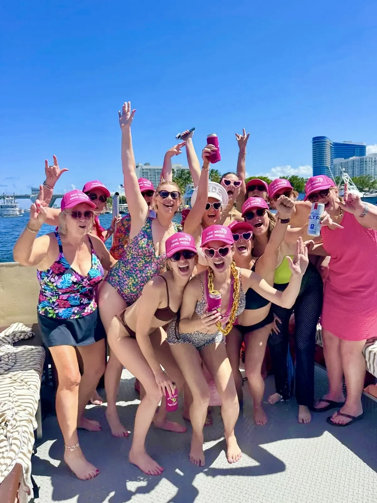 Bachelorette party group in matching pink hats celebrating aboard Freaky Tiki in Fort Lauderdale