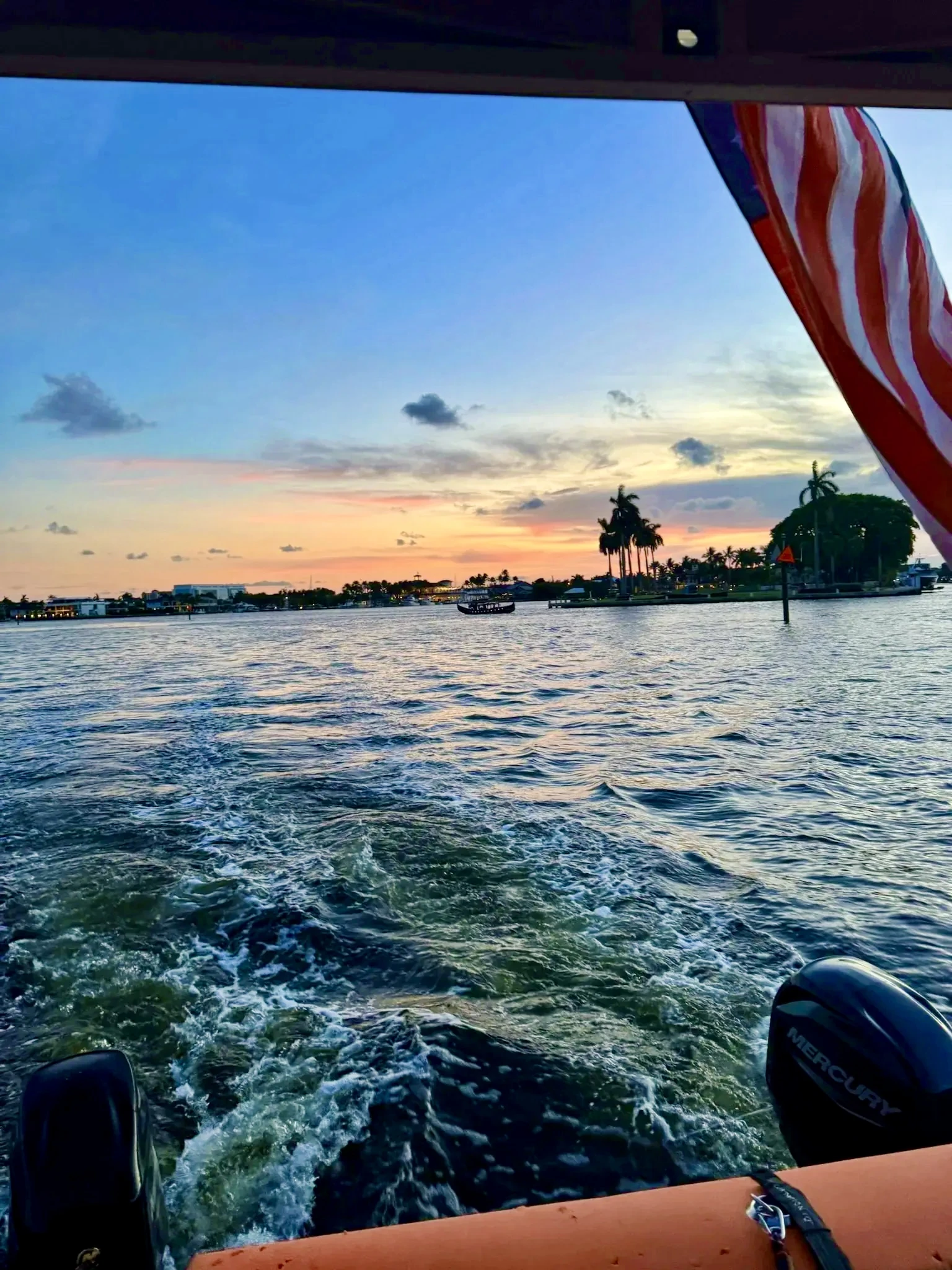 Pastel sunset over the Fort Lauderdale Intracoastal seen above Freaky Tiki's wake and outboard motors